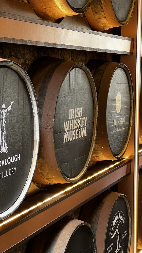 Barrels at the Irish Whiskey Museum in Dublin showcasing whiskey brands.